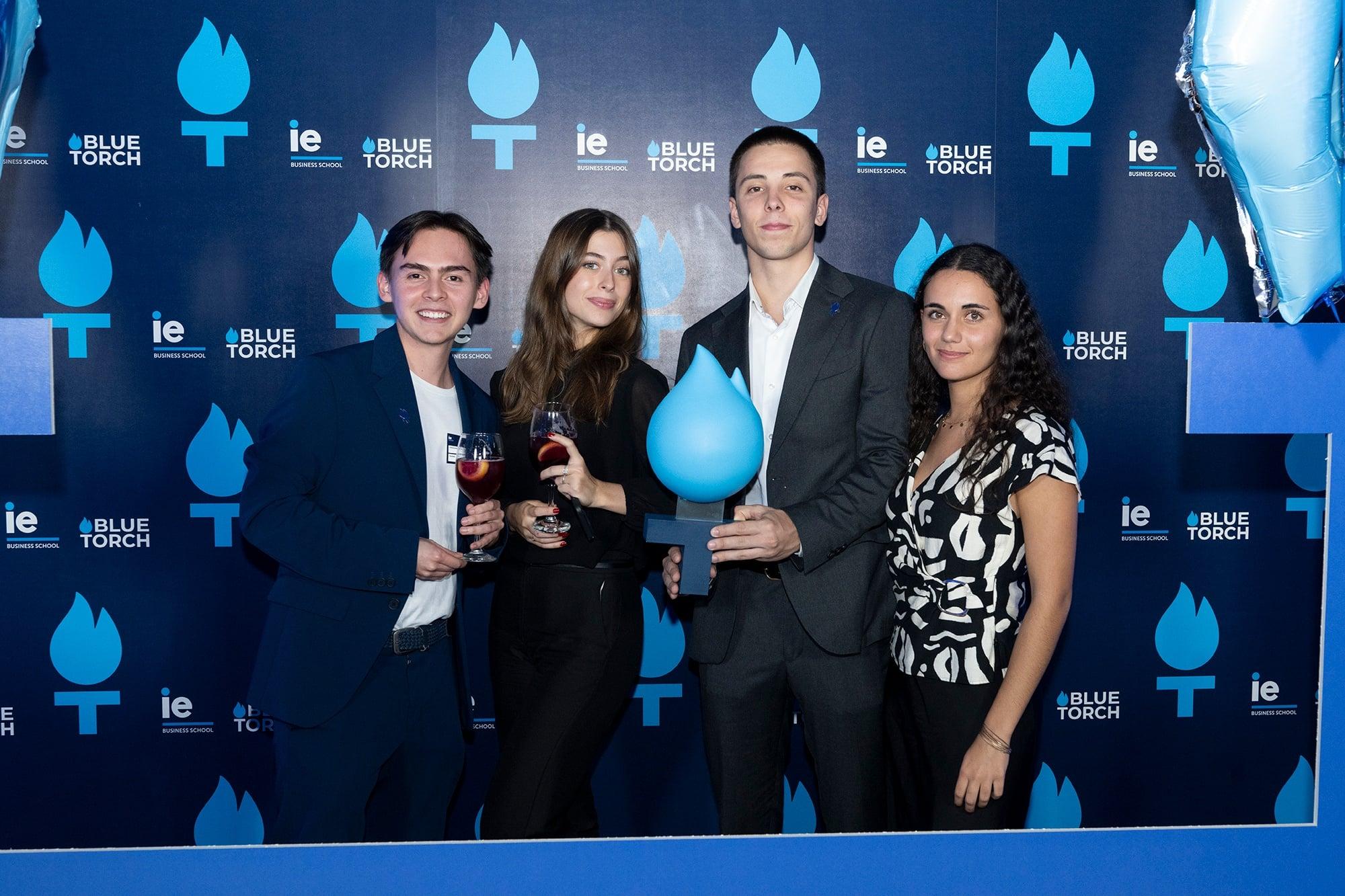 Juan Felipe with his team and their trophy at an awards evening.